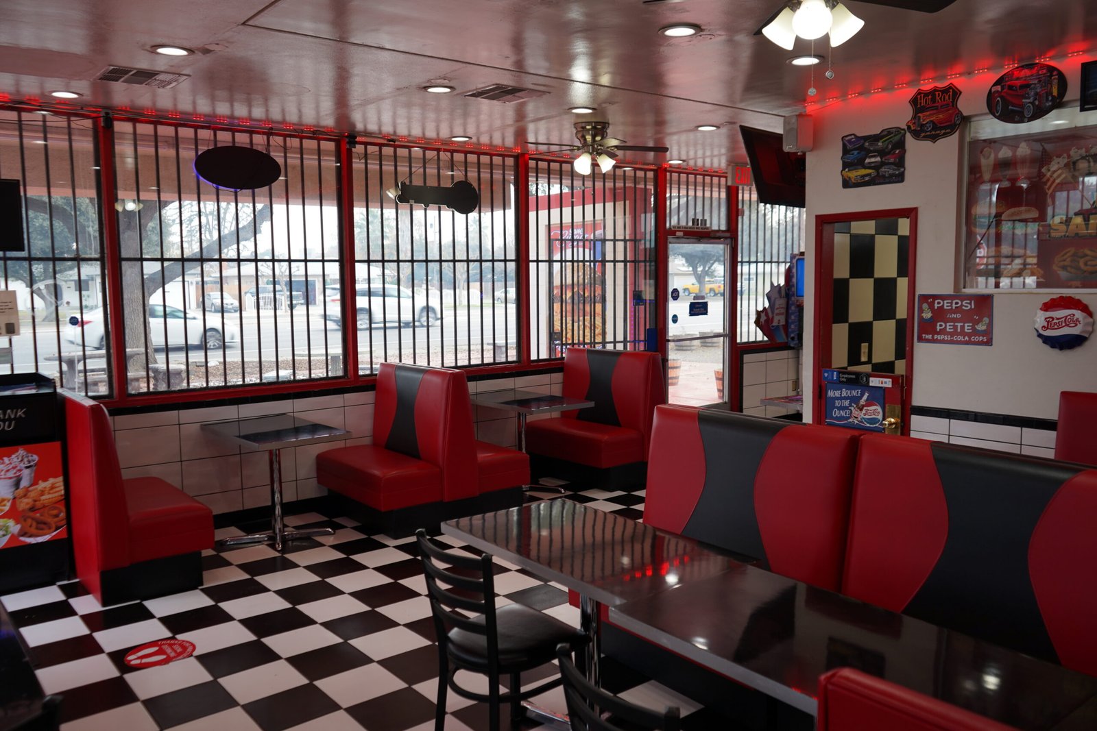 Sam's Burger interior — classic American diner with red booths and checkered floor